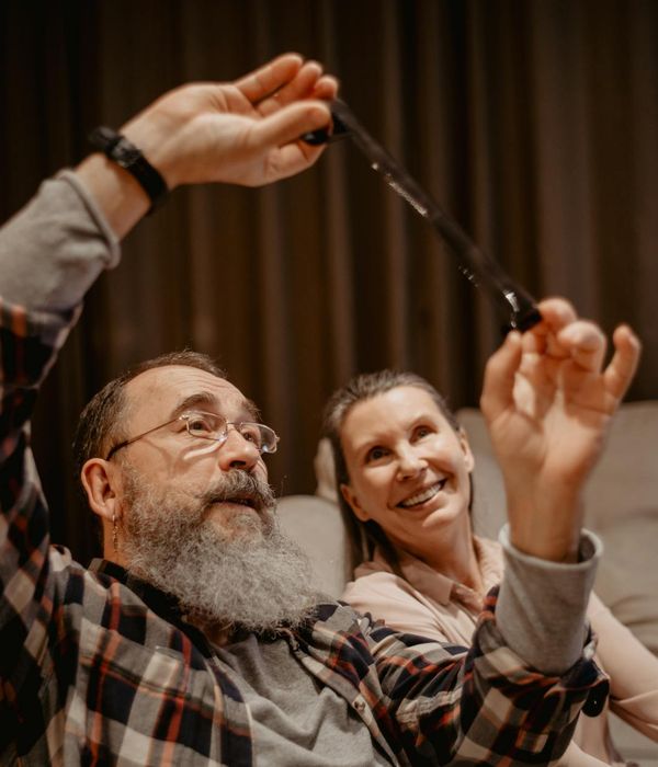 A woman smiling and stretching gently on a yoga mat.