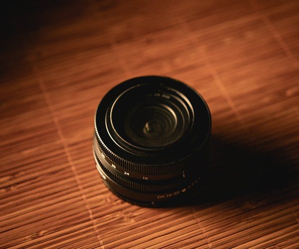 Close-up of yoga equipment on a dark wooden floor.